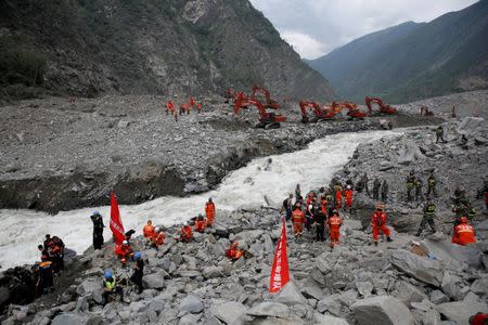 FILE PHOTO: Rescue workers search for survivors at the site of a landslide in the village of Xinmo, Mao County, Sichuan Province, China June 26, 2017. REUTERS/Aly Song/File Photo