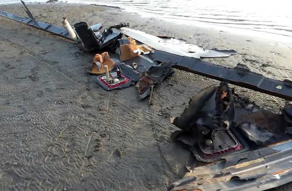 In this handout image provided by the Houthi media center, wreckage of an alleged US drone which Yemen's Houthi group forces claim they shot down lies on the ground on Feb. 20, 2024 in Alhudaydah province, Yemen.