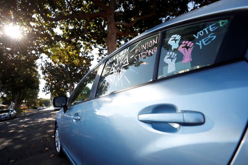 FILE PHOTO: Script coordinator Amy Thurlow, a member of the IATSE Local 871 since 2018, is seen reflected in the side-view mirror of her car