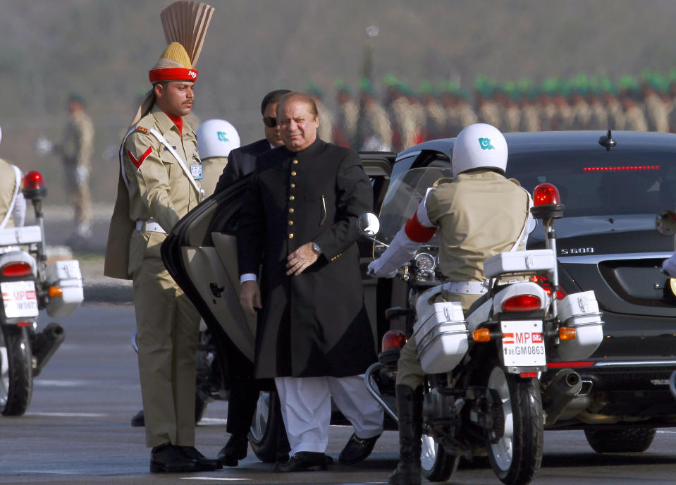 Pakistan's prime minister Nawaz Sharif, center, arrives to attend a military parade to mark Pakistan's Republic Day, in Islamabad, Pakistan, Thursday, March 23, 2017. President Mamnoon Hussain says Pakistan is ready to hold talks with India on all issues, including Kashmir, as he opened the annual military parade. During the parade, attended by several thousand people, Pakistan displayed nuclear-capable weapons, tanks, jets, drones and other weapons systems. (AP Photo/Anjum Naveed)