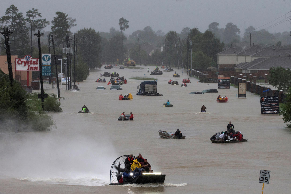 Residents evacuate by boat along submerged Tidwell Road in Houston on Aug. 28. (Photo: Adrees Latif/Retuers)