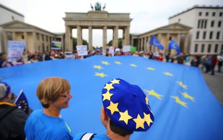 Demonstrators hold an EU flag during a rally under the slogan "Stop the Coup" to protest against attempts to force through a no-deal Brexit, in Berlin