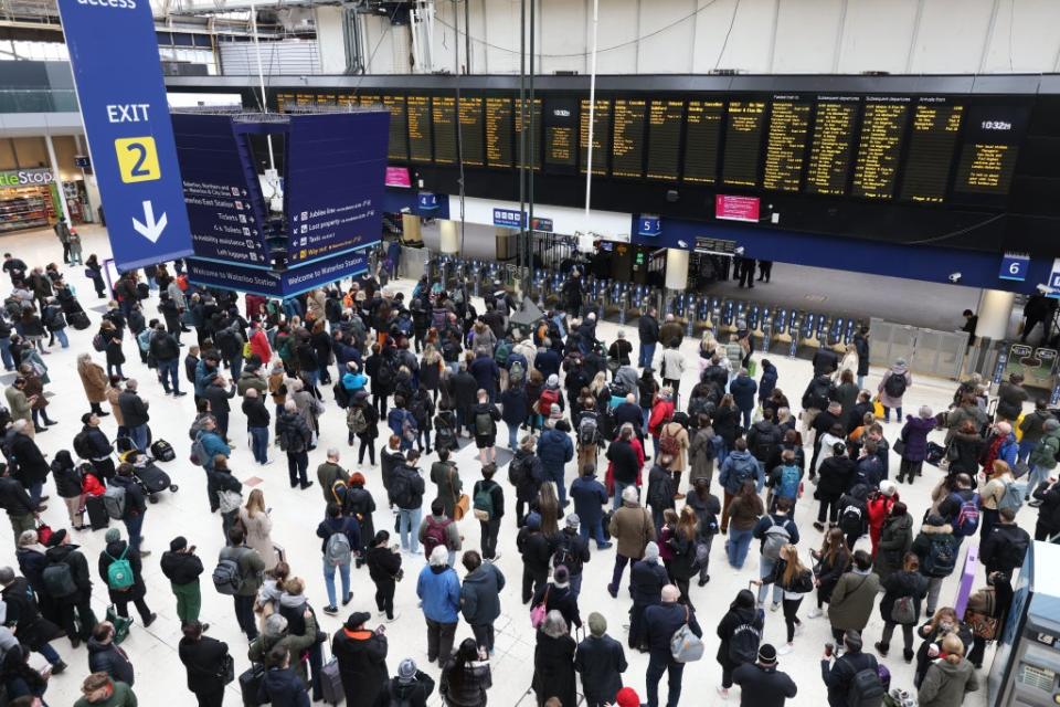 Passengers wait at Waterloo station for cancelled or delayed trains in the aftermath of Storm Eunice on Friday (James Manning/PA) (PA Wire)