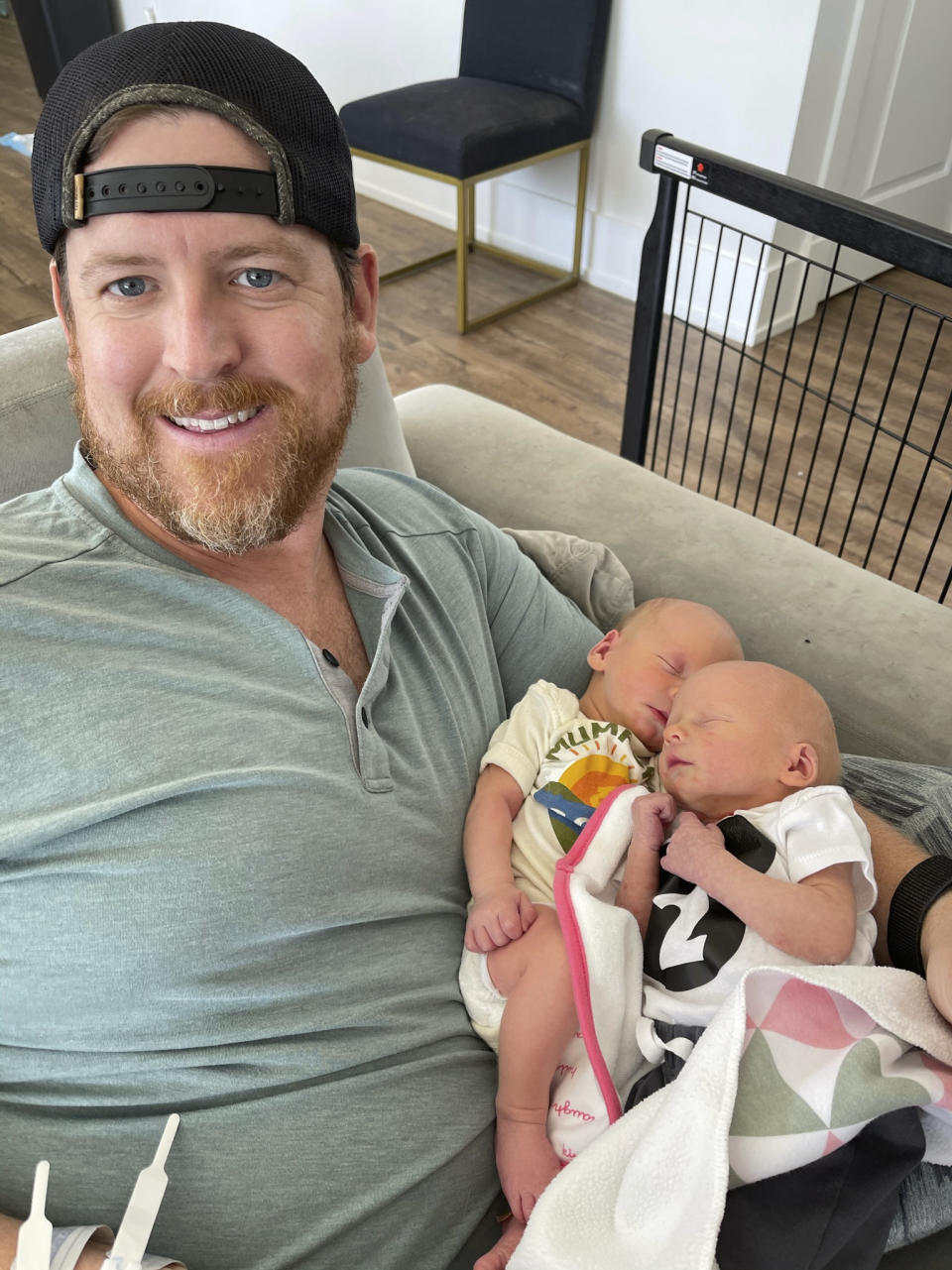 In this family photo, Justin Fell, of Bel Air, Md., holds his twin sons, Hayden, left, and Cameron. The last bedtime of 17-month-old Hayden's life was heartbreakingly normal. Crib video shows the toddler in pajamas playing happily as his parents and sister sang “Wheels on the Bus” with his twin brother. The next morning, Hayden’s dad couldn’t wake him. (Family Photo via AP)