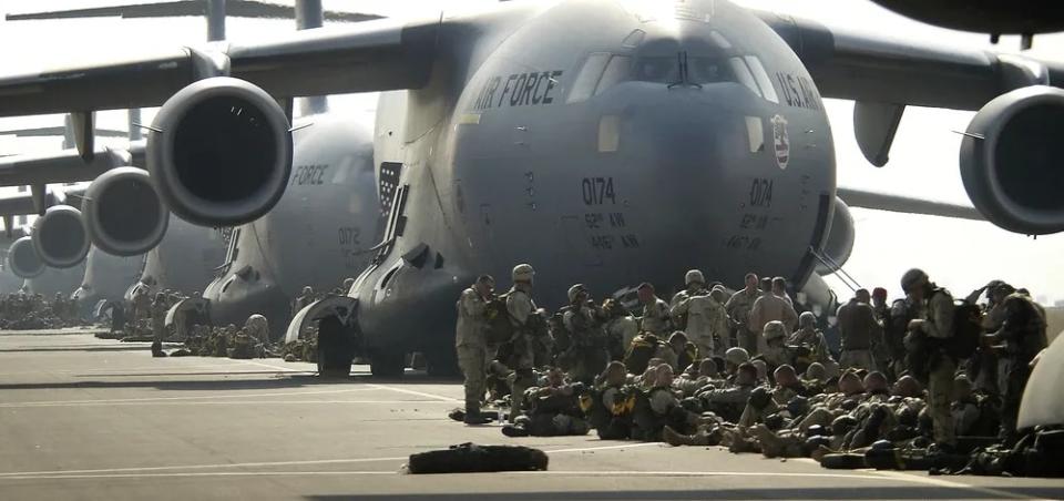 U.S. Army paratroopers prepare to board an Air Force C-17 Globemaster III in Italy, during Operation Iraqi Freedom, March 26, 2003. Nearly 1,000 