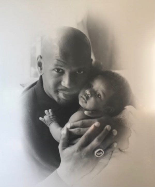 Jaren Jackson Jr. as a baby being held by his father Jaren Jackson Sr.