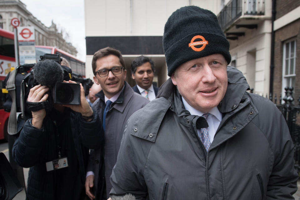 Boris Johnson is followed by media after leaving the Cabinet office in Westminster.