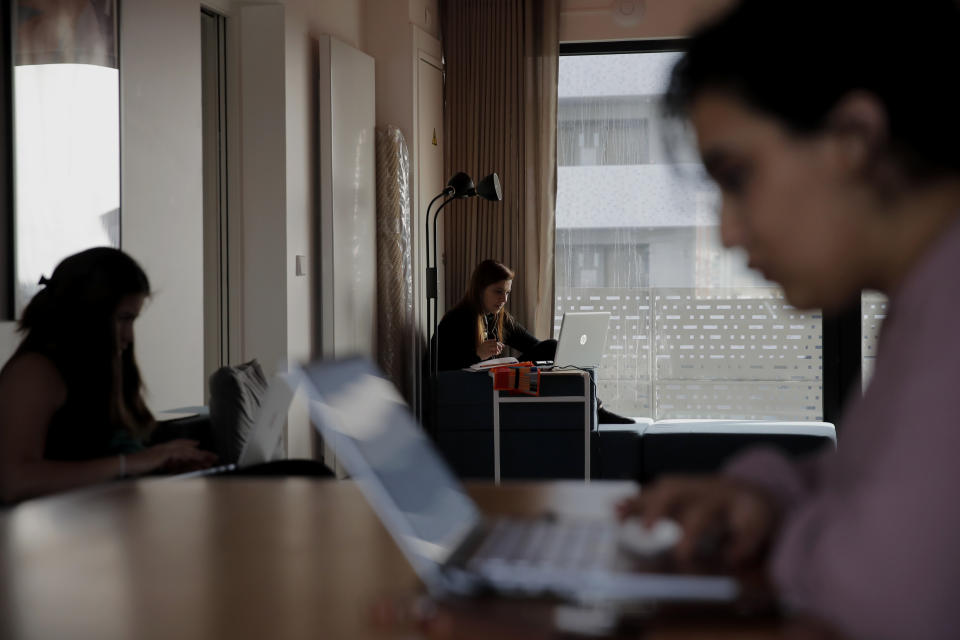 Nouhaila Fakhor from Morocco, a student of commerce, right, Lina Maria Fajardo of Colombia, a student in psychiatry of elderly people, center, and Claudia Danae Diaz Axtble from Mexico study in their student housing in Ivry sur Seine, outside Paris, Thursday, Feb. 11, 2021. (AP Photo/Christophe Ena)