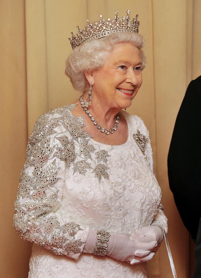 In a gown decorated with maple leaves