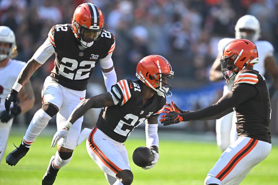 Cleveland Browns cornerback Denzel Ward (21) celebrates his interception with safety Grant Delpit (22) and safety Juan Thornhill (1) during a game against the Arizona Cardinals on Nov. 5, 2023, in Cleveland.