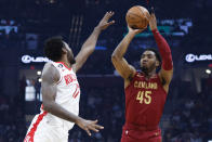 Cleveland Cavaliers guard Donovan Mitchell (45) shoots against Houston Rockets forward Tari Eason (17) during the first half of an NBA basketball game, Sunday, March 26, 2023, in Cleveland. (AP Photo/Ron Schwane)