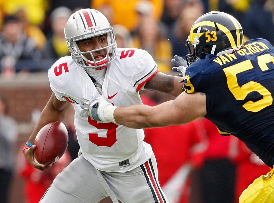 Ohio State Buckeyes quarterback Braxton Miller (5) breaks lose from Michigan Wolverines defensive end Ryan Van Bergen (53) in the 3rd quarter during their NCAA college football game in Michigan Stadium, Ann Arbor, Michigan November 26, 2011. (Dispatch photo by Kyle Robertson)