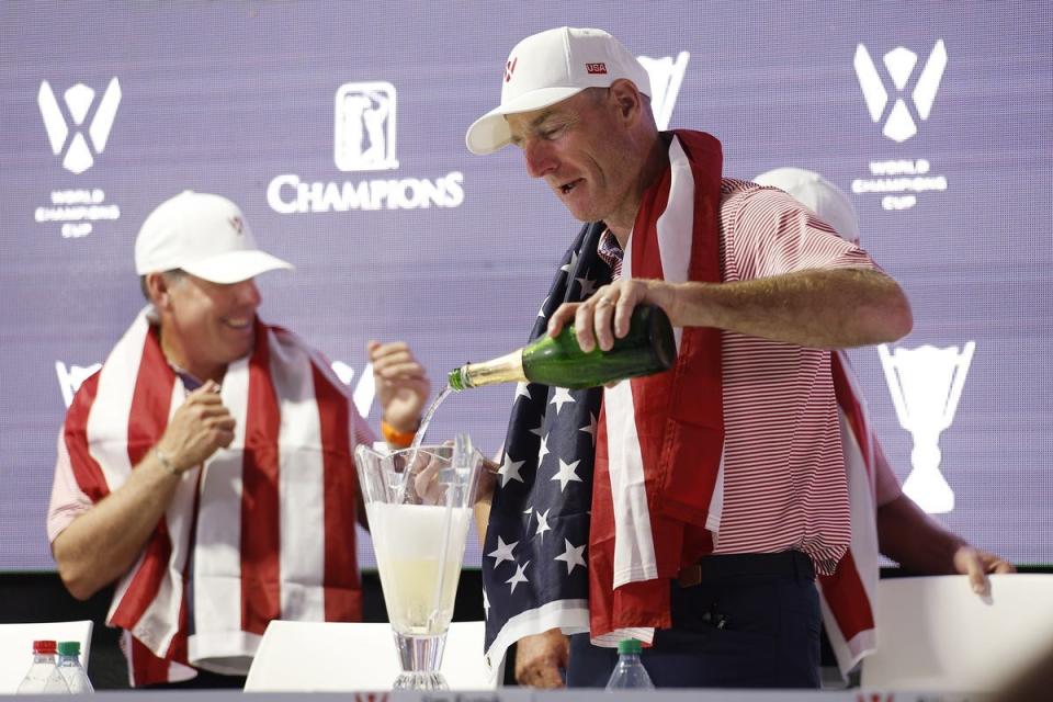 Dec 10, 2023; Bradenton, Florida, USA; Team USA captain, Jim Furyk fills up the World Champions Cup trophy to celebrate at The Concession Golf Club. Mandatory Credit: Jeff Swinger-USA TODAY Sports