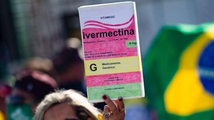 A supporter of Brazil President Jair Bolsonaro holds a large box of Ivermectin, the anti-parasite drug a group of Arkansas prisoners say their jail’s medical staff gave them last year without their consent to treat COVID-19. (Photo: Andressa Anholete/Getty Images)