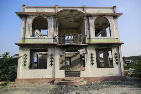 A house that was burnt in 2013 during anti-Muslim violence and unrest is seen in Meiktila, May 14, 2015. REUTERS/Soe Zeya Tun