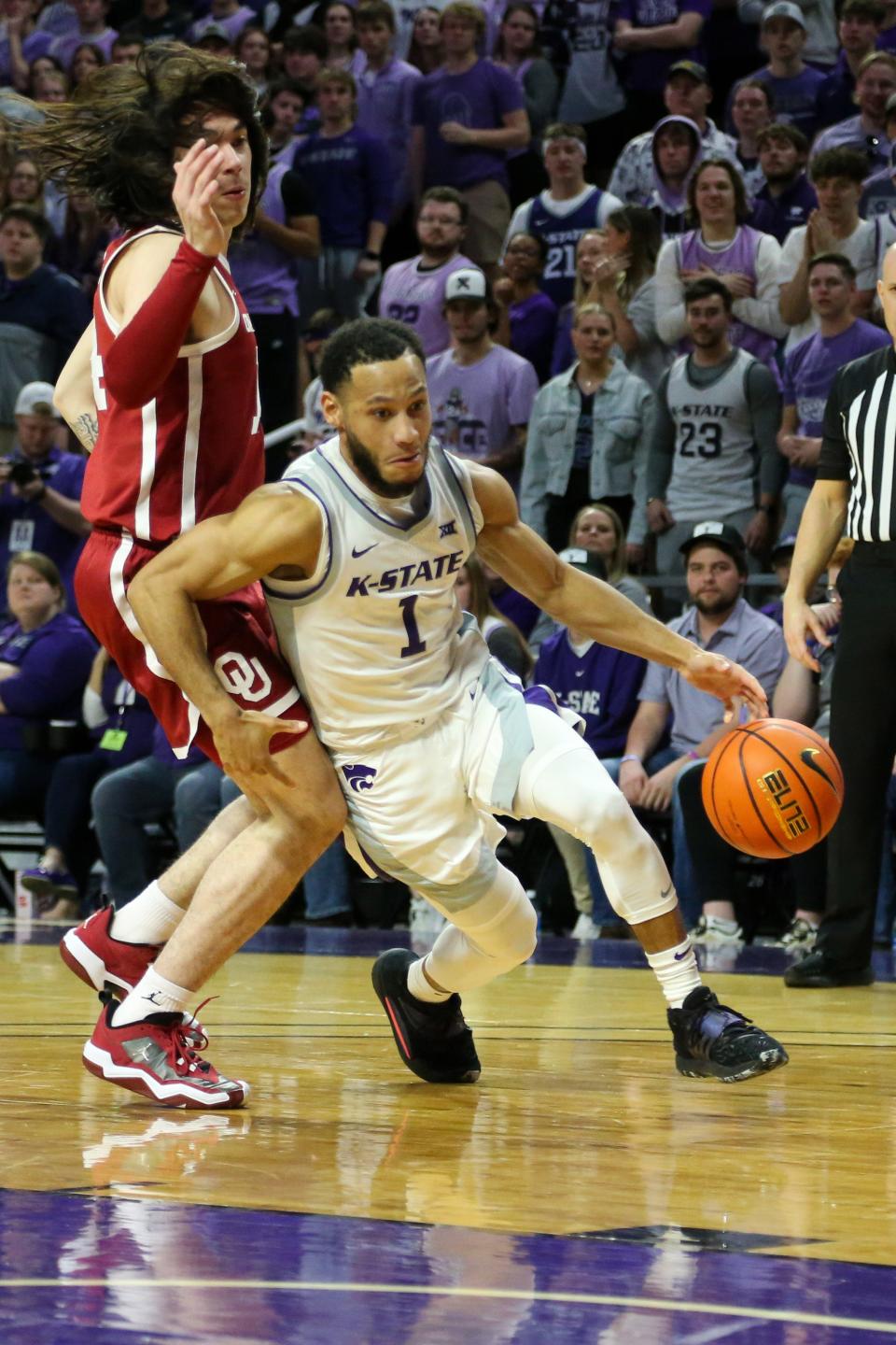 Kansas State guard Markquis Nowell (1) dribbles past Oklahoma's Bijan Cortes (14) on Wednesday night at Bramlage Coliseum. Nowell had 11 points and 10 assists in the Wildcats' 85-69 victory.
