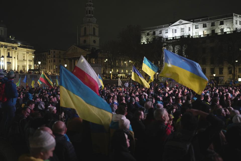 People attend a vigil at the Trafalgar Square organised by the Ukrainian and US Embassy, ahead of the one-year anniversary of the invasion of Ukraine, in London, Thursday, Feb. 23, 2023. (AP Photo/Kin Cheung)