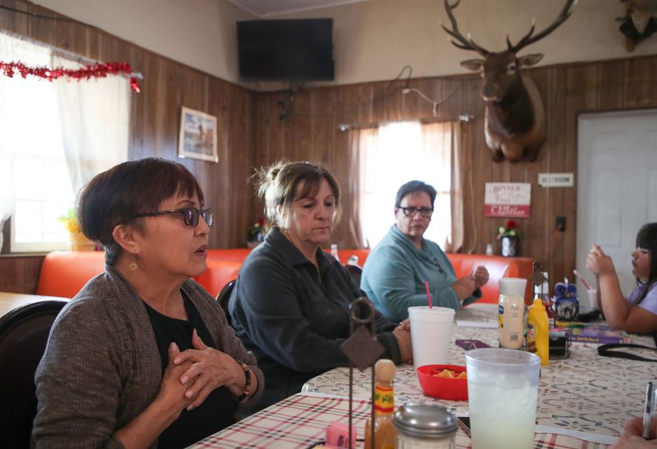 Niland and Calipatria residents talk about the high prices they pay for water from the Golden State Water Co. while meeting at the Buckshot Deli and Diner in Niland, Calif., March 2, 2023. From left, Anna Garcia, Gloria Saiza and Diana Juarez, with Juarez' granddaughter. Juarez says she cannot even afford to buy her grandchildren a kiddie pool because of the high water costs to fill it.