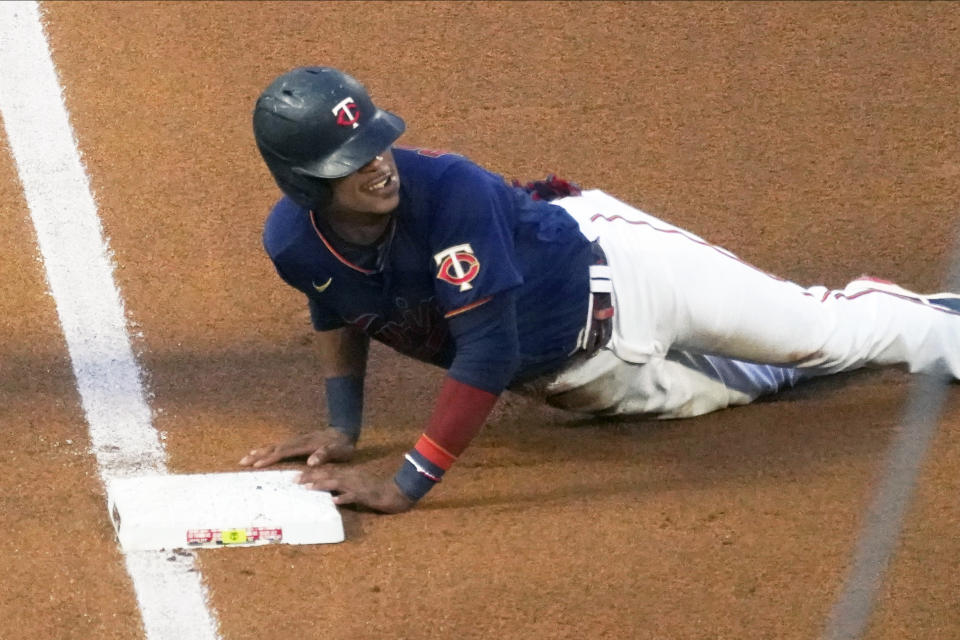 Minnesota Twins' Jorge Polanco slides safely into third base as he advanced on a single by Max Kepler off Detroit Tigers pitcher Matt Manning in the fifth inning of a baseball game, Friday, July 9, 2021, in Minneapolis. (AP Photo/Jim Mone)