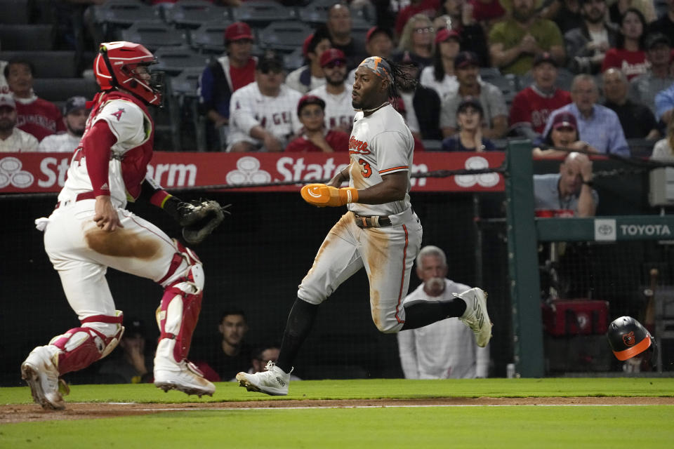 Baltimore Orioles' Jorge Mateo, right, scores on a single by Adley Rutschman as Los Angeles Angels catcher Logan O'Hoppe wits for the ball during the third inning of a baseball game Tuesday, Sept. 5, 2023, in Anaheim, Calif. (AP Photo/Mark J. Terrill)