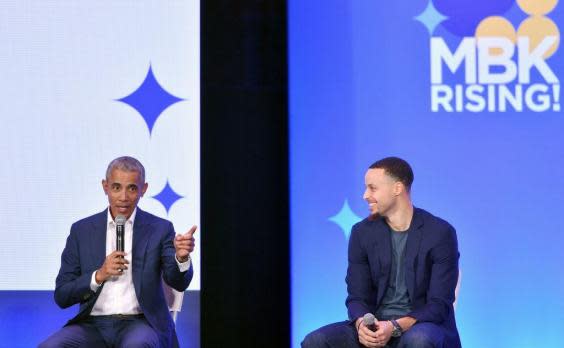 Former President Barack Obama speaks alongside Golden State Warriors basketball player Stephen Curry during the MBK Rising! My Brother's Keeper Alliance Summit in Oakland (AFP/Getty Images)