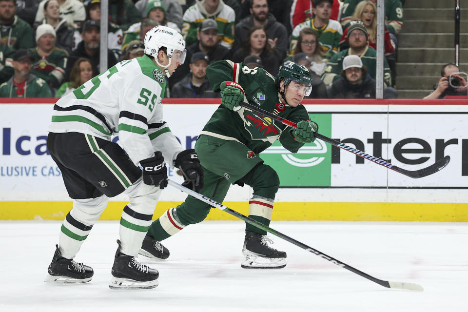 Minnesota Wild center Connor Dewar (26) shoots as Dallas Stars defenseman Thomas Harley (55) defends during the second period of an NHL hockey game Monday, Jan. 8, 2024, in St. Paul, Minn. (AP Photo/Matt Krohn)