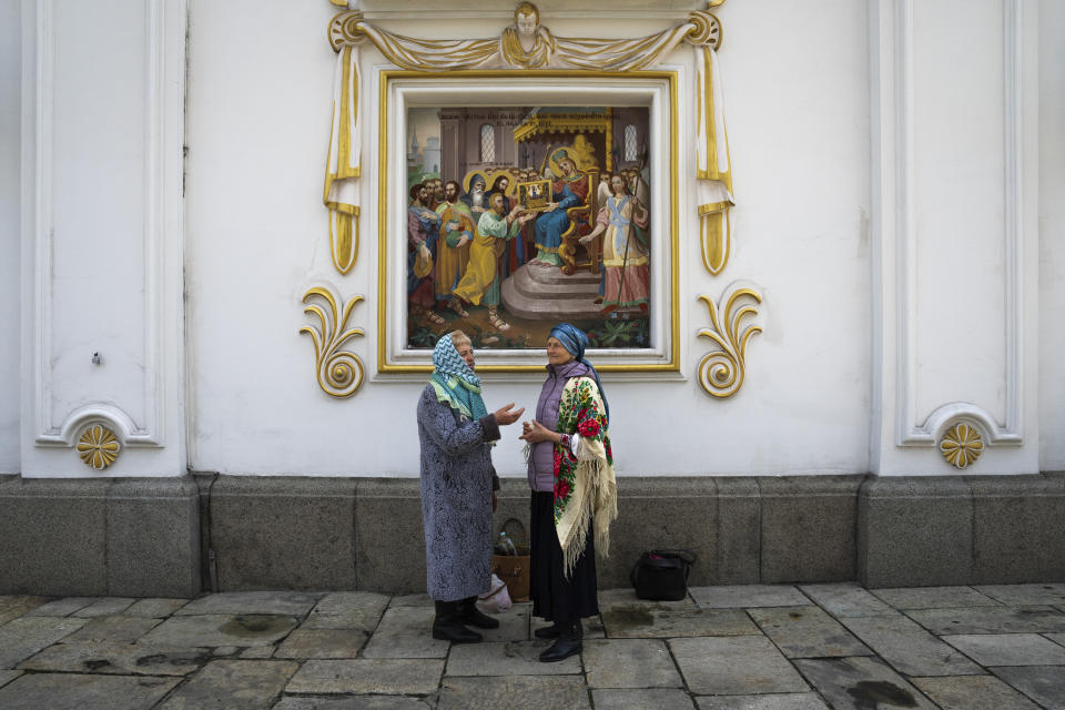Worshipers talk as they celebrate Palm Sunday at Kiev-Pechersk Lavra monastery, Ukraine's most revered Orthodox site in Kyiv, Ukraine, Sunday, April 9, 2023. (AP Photo/Adam Pemble)