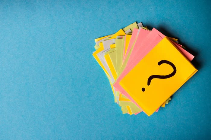 Question marks drawn on brightly colored note cards.