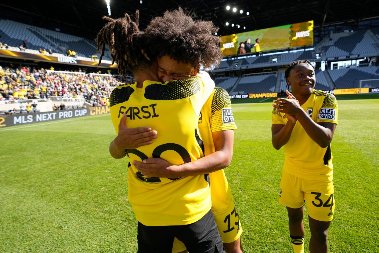 Oct 8, 2022; Columbus, Ohio, USA; Columbus Crew 2 Jacen Russell-Rowe (13) hugs Mohamed Farsi (20) following their 4-1 win over St. Louis CITY2 in the MLS NEXT Pro Cup Championship at Lower.com Field. Mandatory Credit: Adam Cairns-The Columbus Dispatch