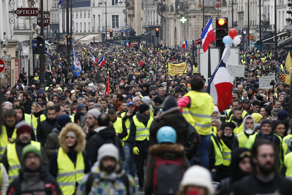 Yellow vest protesters demonstrate peacefully in the streets of Paris, France, Saturday, Jan. 12, 2019. Authorities deployed 80,000 security forces nationwide for a ninth straight weekend of anti-government protests. (AP Photo/Thibault Camus)