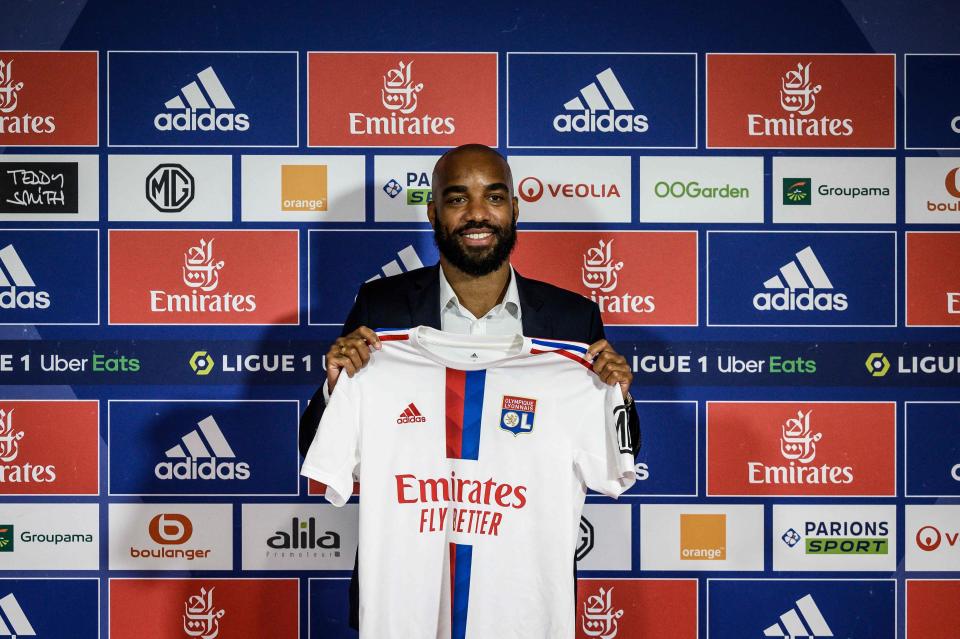 Former France international Alexandre Lacazette poses with his jersey during a press conference to announce his return to Ligue 1 Olympique Lyonnais (AFP via Getty Images)