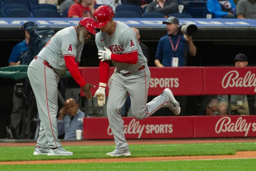 Los Angeles Angels third base coach Eric Young Sr., left, congratulates California Angels’ Micky Moniak after his three-run home run off Cleveland Guardians starting pitcher Tanner Bibee during the fourth inning of a baseball game in Cleveland Friday, May 3, 2024. (AP Photo/Phil Long)