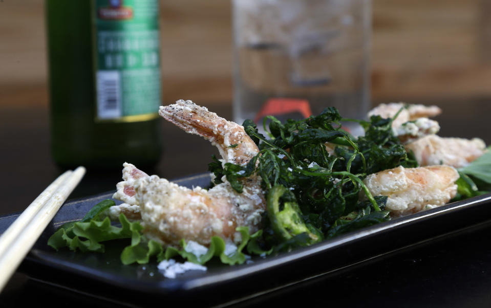 Salt and pepper shrimp, prepared by Chef Andrea Reusing at Lantern in Chapel Hill, N.C., Wednesday, April 10, 2013. Southern food may be the country's only true regional cuisine. But its reputation for fried chicken, collard greens and biscuits is being challenged by an unlikely source: Yankee chefs. In North Carolina, New Jersey native Reusing adds seven-spice, tamarind and other Asian flavors to pork and shrimp. (AP Photo/Gerry Broome)