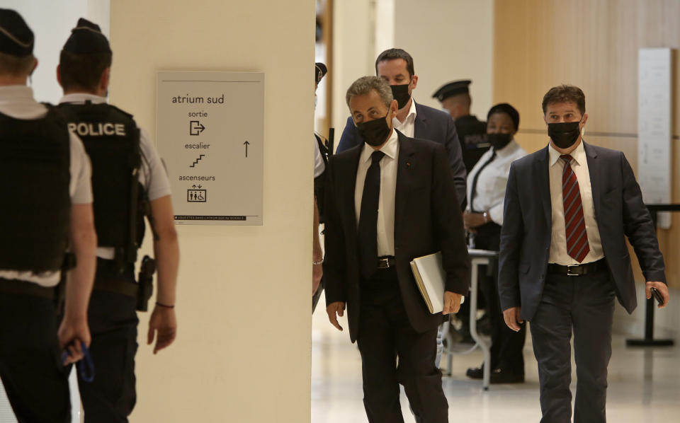 Former French President Nicolas Sarkozy, center, arrives at the court room in Paris, Tuesday, June 15, 2021. Nicolas Sarkozy goes trial on charges that his unsuccessful reelection bid was illegally financed. (AP Photo/Rafael Yaghobzadeh)