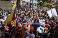 Opposition leaders Juan Guaido, center left, and Freddy Superlano, greet supporters during a demonstration in support of Superlano, in Barinas, Venezuela, Saturday, Dec. 4, 2021. Superlano, who was leading the race for governor in Barinas State in the recent Nov. 21 regional elections, called for a protest this Saturday after a court ruling ordered new elections in the state and disqualified him from running. (AP Photo/Ariana Cubillos)