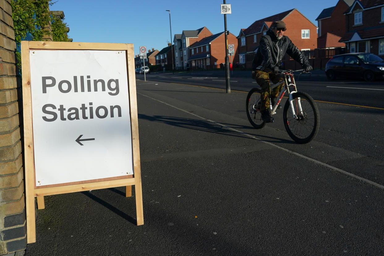 HARTLEPOOL, ENGLAND - MAY 06: A man cycles past a polling station as voting begins in the Hartlepool by-election on May 06, 2021 in Hartlepool, England. Today voters in Hartlepool will decide between returning a Labour Party MP, who has held the seat since its creation in 1974, and the Conservative Party candidate who took a number of Labour's so-called 