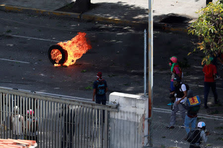 Demonstrators block a street at a rally during a strike called to protest against Venezuelan President Nicolas Maduro's government in Caracas, Venezuela July 26, 2017. REUTERS/Marco Bello