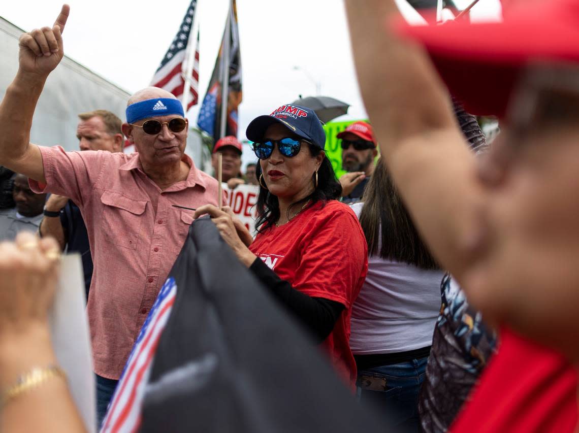 Osvaldo Hernandez, left, and Maribel Gonzalez stand outside of Trump National Doral on Monday, June 12, 2023, in Doral, Fla. Supporters of former President Donald Trump gathered outside his hotel one day before his expected arraignment in Miami federal court on Tuesday. Trump arrived at the hotel Monday afternoon. MATIAS J. OCNER/mocner@miamiherald.com