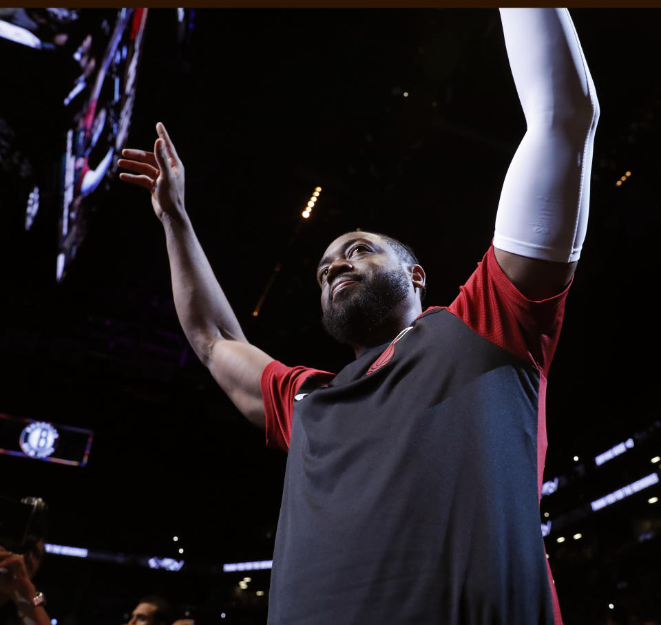 Miami Heat guard Dwyane Wade acknowledges the crowd before the team's NBA basketball game against the Brooklyn Nets, Wednesday, April 10, 2019, in New York. Wade is retiring after the game. (AP Photo/Kathy Willens)