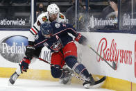 Chicago Blackhawks' Dominik Kubalik, left, and Columbus Blue Jackets' Seth Jones fight for the puck during the first period of an NHL hockey game Saturday, April 10, 2021, in Columbus, Ohio. (AP Photo/Jay LaPrete)