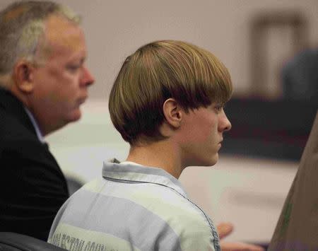 Dylann Roof (R), the 21-year-old man charged with murdering nine worshippers at a historic black church in Charleston last month, listens to the proceedings with assistant defense attorney William Maguire during a hearing at the Judicial Center in Charleston, South Carolina in this July 16, 2015 file photo. REUTERS/Randall Hill/Files