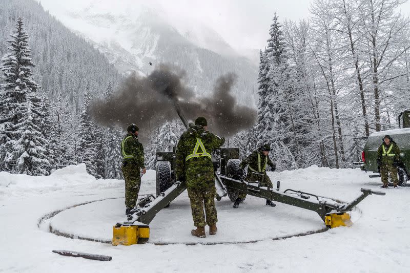 Gunners from Royal Canadian Horse Artillery fire howitzer at snow pack at Rogers Pass