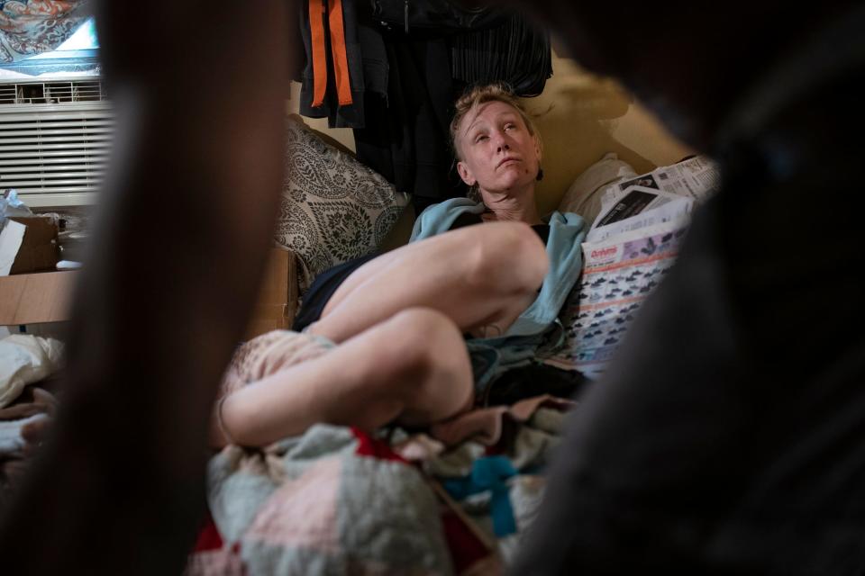 Amanda looks up at her boyfriend, P., during an argument over missing money after they use drugs in the bedroom she rents in an east-side bungalow in Detroit on Monday, July 25, 2022. Misunderstandings happen often in the fog of drug use.