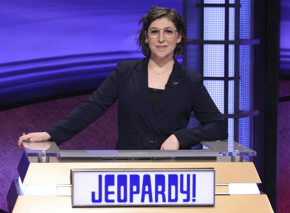 FILE - In this image provided by Jeopardy Productions, Inc., guest host Mayim Bialik appears on the set of "Jeopardy!" TV’s smartest game show was clueless when it mattered: replacing its beloved host Alex Trebek. “Jeopardy!” made executive producer Mike Richards the surprise pick, then in August bid him farewell because of unsavory past podcast remarks. Mayim Bialik, set to host prime-time “Jeopardy!” specials, filled in with an assist from an all-time champ, Ken Jennings. (Carol Kaelson/Jeopardy Productions, Inc. via AP, File)