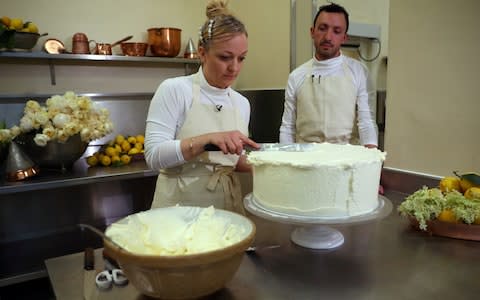 Ms Ptak, left, said Harry and Meghan had enjoyed trying several different samples of cake - Credit: HANNAH MCKAY/REUTERS