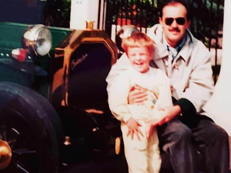 Fabrizio as a young boy with his father in front of a Ford.