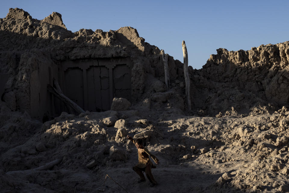 A boy plays in a house that was destroyed by U.S. forces during a raid in a village in rural Afghanistan, Wednesday, Feb. 22, 2023. The U.S. Defense Department estimates 48,000 civilians were killed and at least 75,000 injured between 2001 and 2021, though the agency acknowledges the true toll is likely significantly higher. (AP Photo/Ebrahim Noroozi)