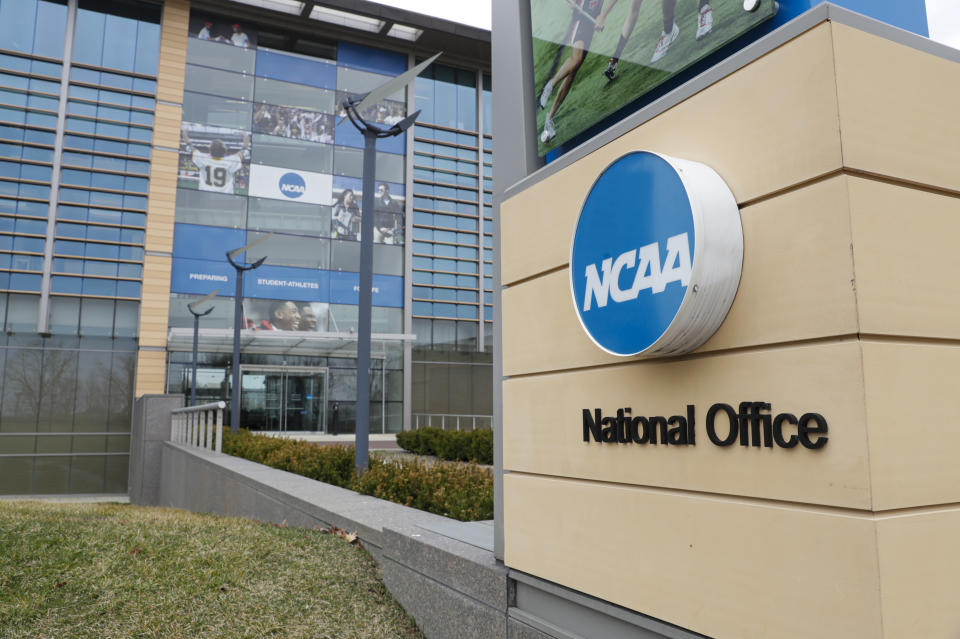 Final Four flag fly over the headquarter of the NCAA in Indianapolis, Thursday, March 12, 2020. (AP Photo/Michael Conroy)