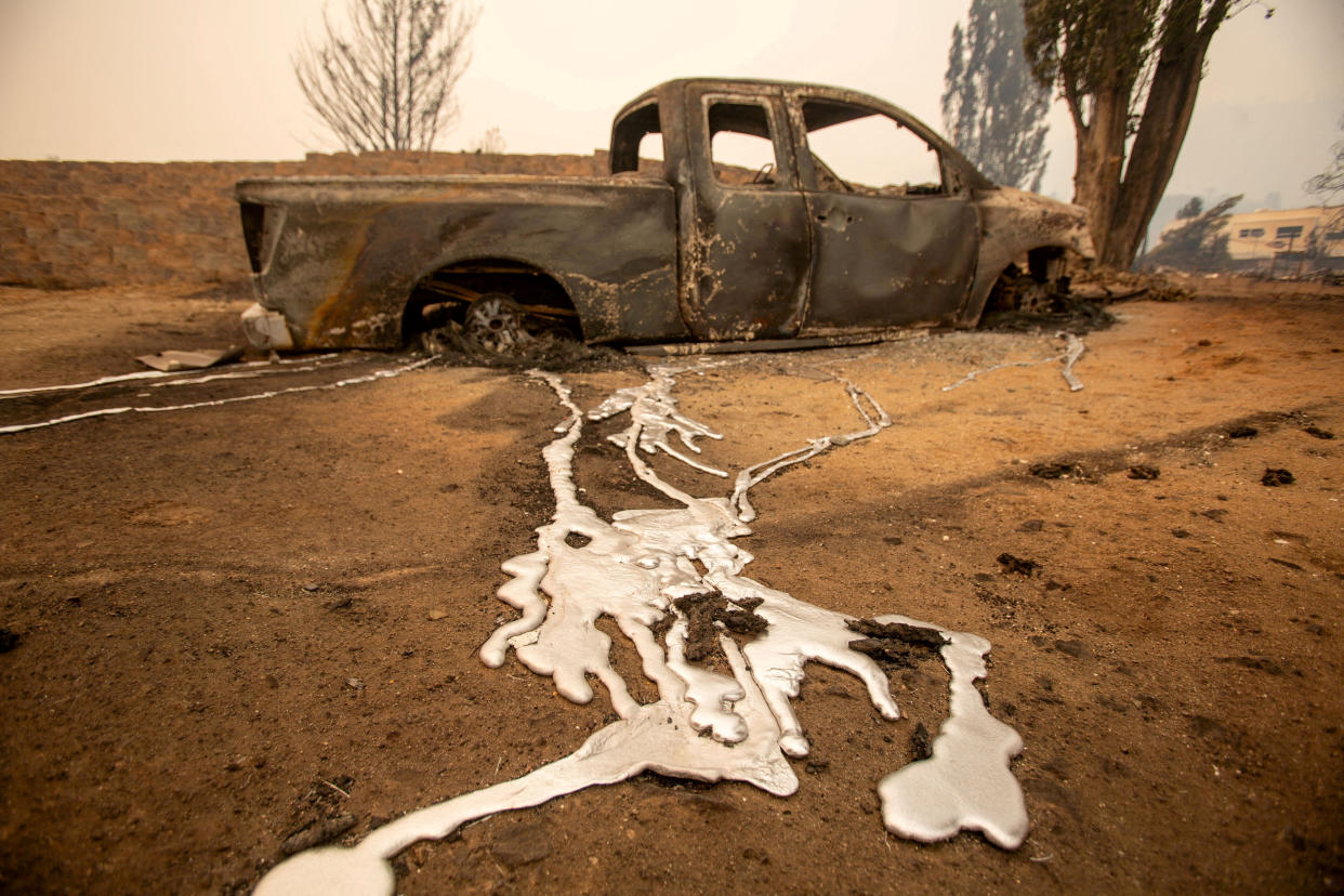 A charred pickup truck is seen in Wrightwood, Calif., on Wednesday.