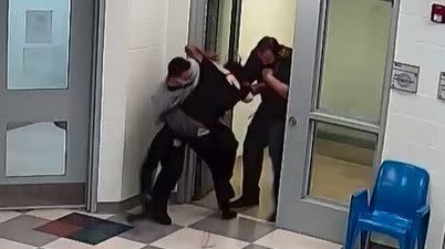 This still image from a security camera provided by Sedgwick County shows Cedric "CJ" Lofton struggling with staff on Sept. 24, 2021 at the Sedgwick County Juvenile Intake and Assessment Center in Wichita, Kan. Sedgwick County released 18 video clips late Friday, Jan. 21, 2022, of what happened before Lofton was rushed to a hospital on Sept. 24. He died two days later. (Sedgwick County via AP)